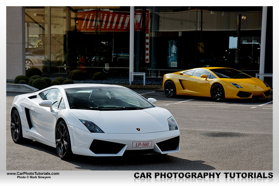 A white Gallardo LP5604 with a similar yellow one in the background