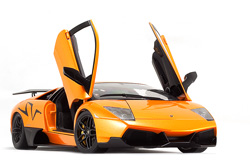 A bright orange car on a white sheet of paper looks amazing